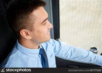 transport, tourism, business trip and people concept - close up of happy bus driver or businessman in shirt and tie