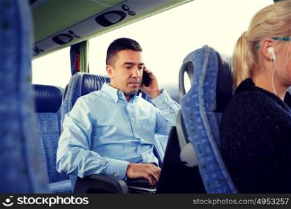 transport, tourism, business trip and people concept - man with smartphone and laptop calling in travel bus. man with smartphone and laptop in travel bus