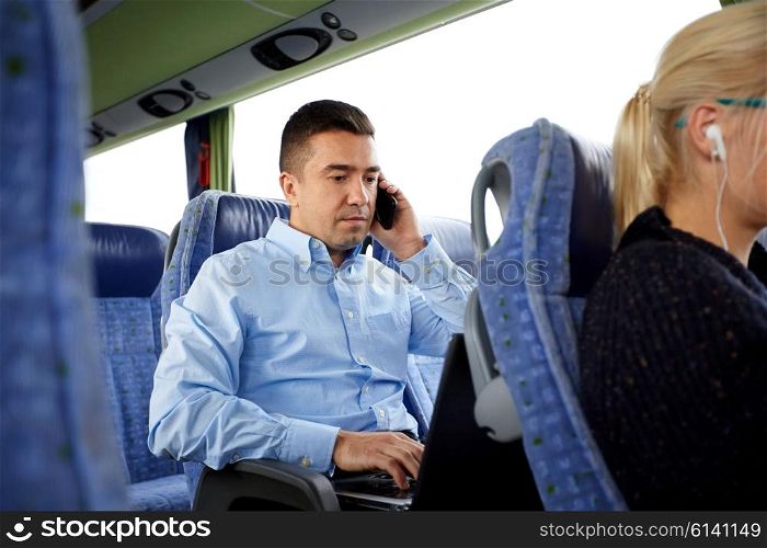 transport, tourism, business trip and people concept - man with smartphone and laptop calling in travel bus