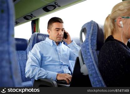 transport, tourism, business trip and people concept - man with smartphone and laptop calling in travel bus