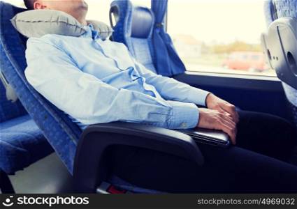 transport, tourism, business trip, comfort and people concept - close up of man sleeping in travel bus with pillow. close up of man sleeping in travel bus with pillow