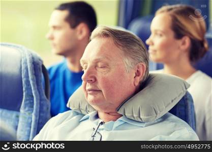 transport, tourism, comfort, road trip and people concept - senior man sleeping in travel bus with neck pillow. senior man sleeping in travel bus with neck pillow