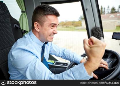 transport, tourism, gesture, emotion and people concept - angry driver showing fist and driving bus