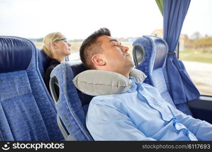 transport, tourism, rest , comfort and people concept - man sleeping in travel bus with cervical neck inflatable pillow