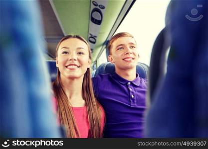 transport, tourism, road trip and people concept - close up of happy teenage couple or tourists in travel bus. happy teenage couple or passengers in travel bus