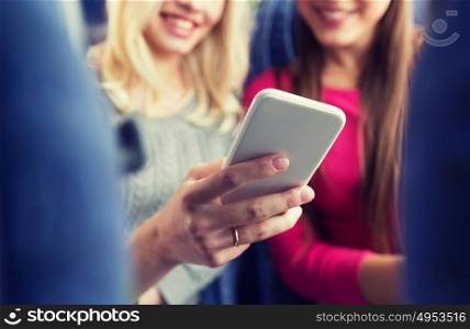 transport, tourism, road trip and people concept - close up of women in travel bus texting or reading message on smartphone. close up of women in travel bus with smartphone