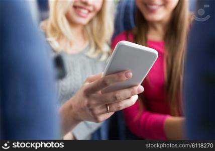 transport, tourism, road trip and people concept - close up of women in travel bus texting or reading message on smartphone