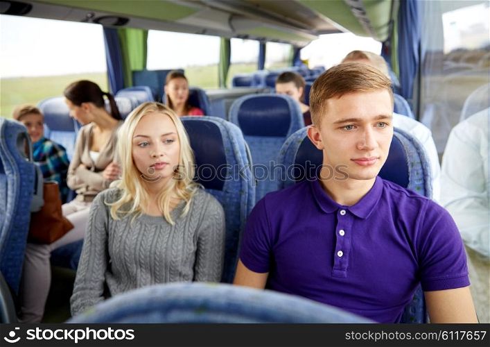 transport, tourism, road trip and people concept - couple with group of passengers or tourists in travel bus