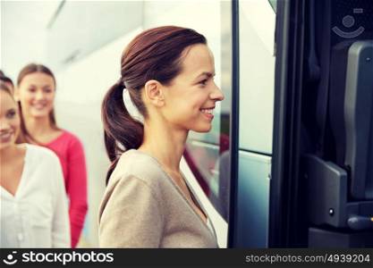 transport, tourism, road trip and people concept - group of happy female passengers boarding travel bus. group of happy passengers boarding travel bus