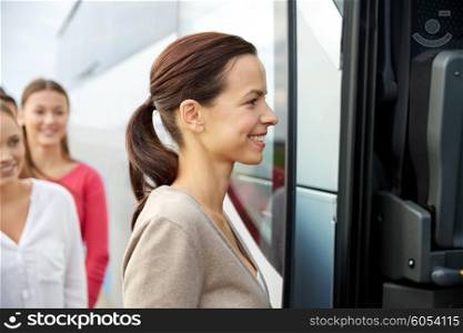 transport, tourism, road trip and people concept - group of happy female passengers boarding travel bus
