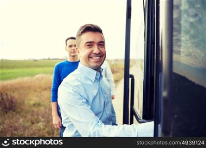 transport, tourism, road trip and people concept - group of happy male passengers boarding travel bus. group of happy male passengers boarding travel bus