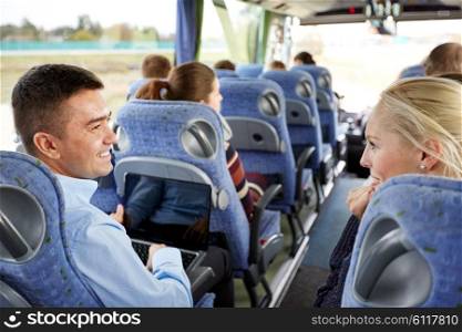 transport, tourism, road trip and people concept - group of happy passengers or tourists in travel bus