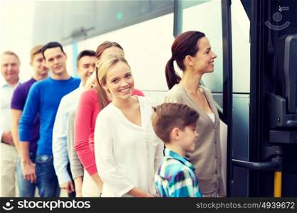 transport, tourism, road trip and people concept - group of happy passengers boarding travel bus. group of happy passengers boarding travel bus