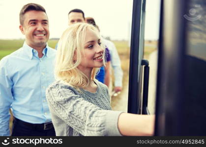 transport, tourism, road trip and people concept - group of happy passengers boarding travel bus. group of happy passengers boarding travel bus