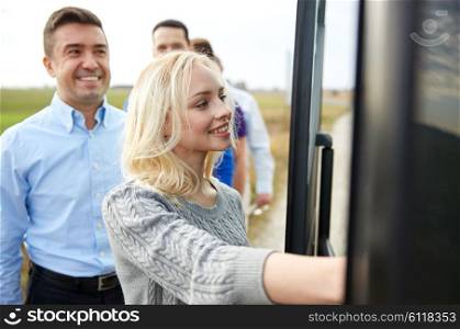 transport, tourism, road trip and people concept - group of happy passengers boarding travel bus