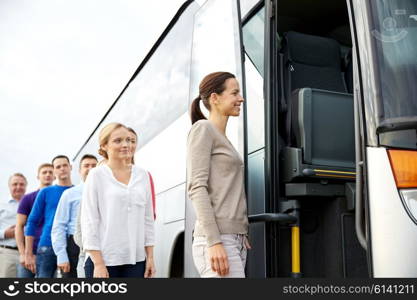 transport, tourism, road trip and people concept - group of happy passengers boarding travel bus