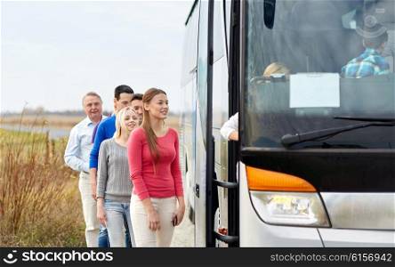 transport, tourism, road trip and people concept - group of happy passengers boarding travel bus