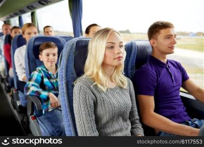 transport, tourism, road trip and people concept - happy couple with group of passengers or tourists in travel bus