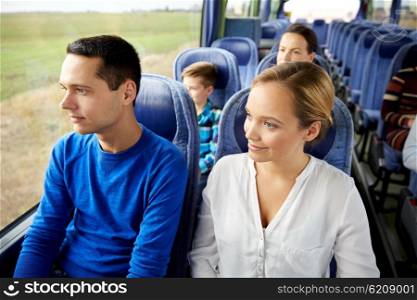 transport, tourism, road trip and people concept - happy couple with group of happy passengers or tourists in travel bus