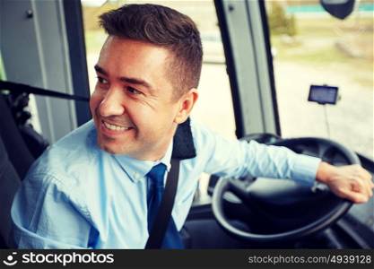 transport, tourism, road trip and people concept - happy driver driving intercity bus. happy driver driving intercity bus