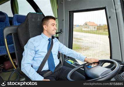 transport, tourism, road trip and people concept - happy driver talking to microphone and driving bus