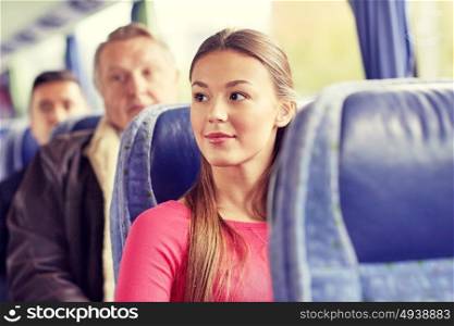 transport, tourism, road trip and people concept - happy young woman sitting in travel bus or train. happy young woman sitting in travel bus or train