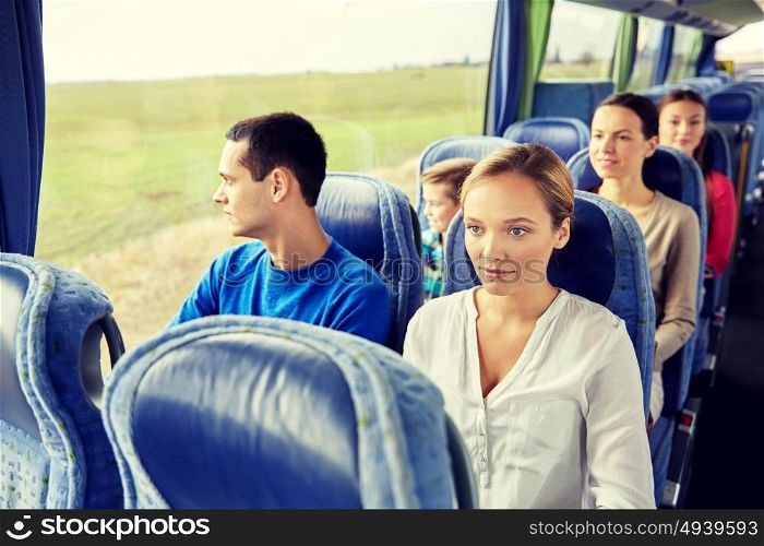 transport, tourism, road trip and people concept - woman with group of passengers or tourists in travel bus. group of passengers or tourists in travel bus