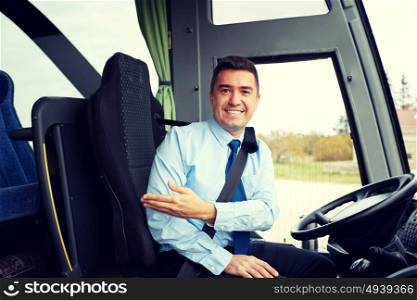 transport, tourism, road trip, gesture and people concept - happy driver inviting on board of intercity bus. happy driver inviting on board of intercity bus