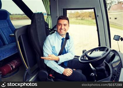 transport, tourism, road trip, gesture and people concept - happy driver inviting on board of intercity bus. happy driver inviting on board of intercity bus