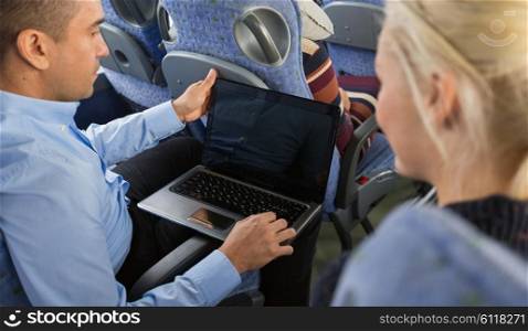 transport, tourism, road trip, technology and people concept - close up of passengers couple with laptop in travel bus