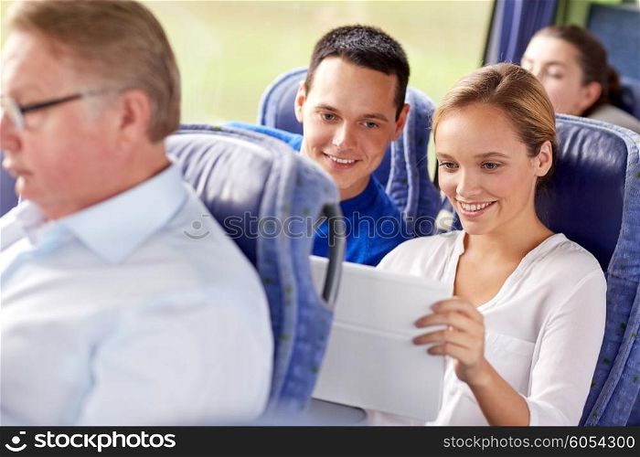 transport, tourism, road trip, technology and people concept - happy couple with tablet pc in travel bus