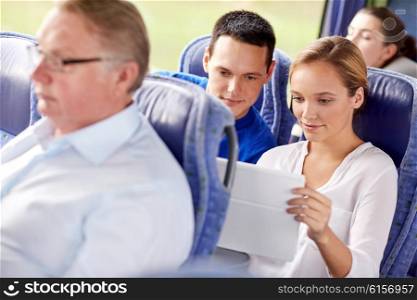 transport, tourism, road trip, technology and people concept - happy couple with tablet pc in travel bus