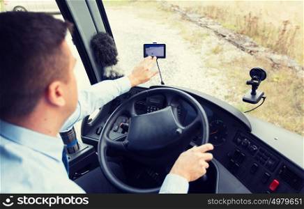 transport, transportation, tourism, navigation and people concept - close up of bus driver with gps navigator driving passenger bus. close up of bus driver driving with gps navigator