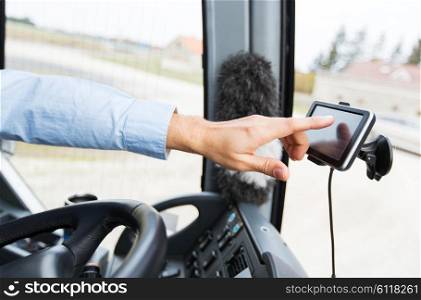 transport, transportation, tourism, navigation and people concept - close up of bus driver with gps navigator driving passenger bus