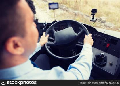 transport, transportation, tourism, road trip and people concept - close up of bus driver steering wheel and driving passenger bus. close up of driver driving passenger bus