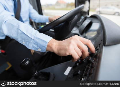 transport, transportation, tourism, road trip and people concept - close up of bus driver driving passenger bus