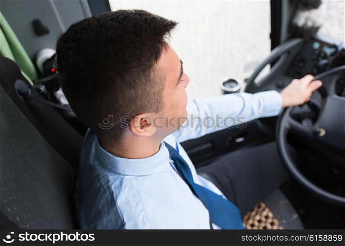 transport, transportation, tourism, road trip and people concept - close up of bus driver steering wheel and driving passenger bus