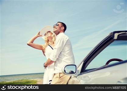 transport, travel, love, date and people concept - happy man and woman hugging near cabriolet car at sea side