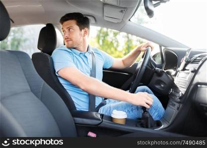 transport, vehicle and driving concept - man or car driver looking back. man or driver driving car and looking back