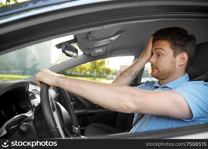 transport, vehicle and driving concept - tired sleepy man or car driver rubbing eyes. tired sleepy man or driver driving car