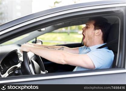 transport, vehicle and driving concept - tired sleepy man or car driver yawning. tired sleepy man or driver driving car and yawning