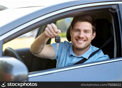 transport, vehicle and ownership concept - happy smiling man or driver with key sitting in car. smiling man or driver with key sitting in car