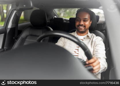 transport, vehicle and people concept - happy smiling indian man or driver driving car. smiling indian man or driver driving car