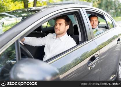 transport, vehicle and people concept - male driver driving car with passenger. male driver driving car with passenger