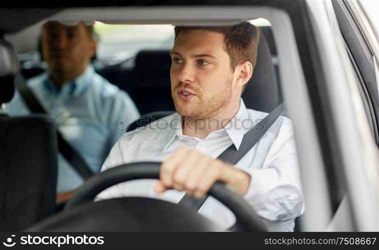 transport, vehicle and people concept - male driver driving car with passenger. male driver driving car with passenger