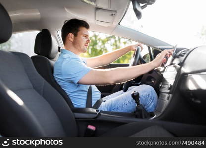 transport, vehicle and people concept - man or driver driving car and using gps navigator. man or driver driving car and using gps navigator