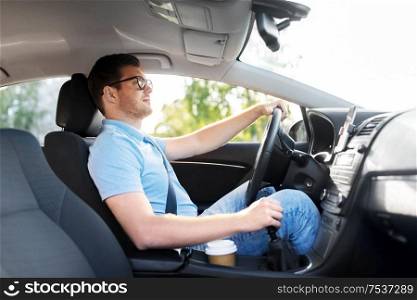 transport, vehicle and people concept - man or driver in glasses driving car in summer. man or driver in glasses driving car in summer
