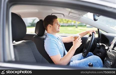 transport, vehicle and people concept - man or driver with takeaway coffee cup driving car. man or driver with takeaway coffee cup driving car