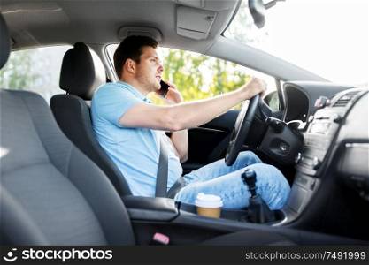 transport, vehicle and people concept - smiling man or driver driving car and calling on smartphone. man driving car and calling on smartphone