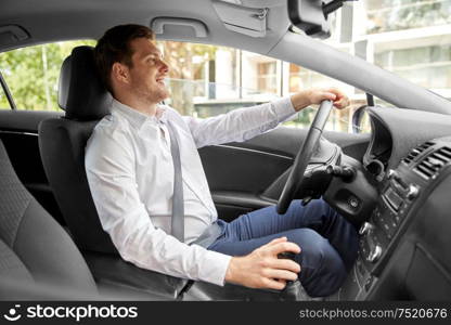 transport, vehicle and people concept - smiling man or driver driving car in summer. smiling man or driver driving car